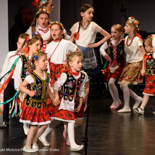 "Matulu, wyjrzyj na próg chaty" - występ Małych Świerczkowiaków - Grupa dziewczynek w kolorowych strojach ludowych tańczy w parach w półkole, trzymając się za ręce. - Fot. : Przemysław Sroka