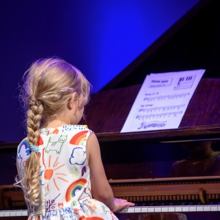 MiniLab - zakończenie roku 2020/2021 - Dziewczynka w kolorowej sukience gra na fortepianie.  - Fot. :Przemysław Sroka
