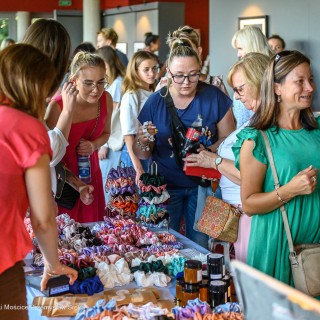 Babski Poniedziałek - Miłość na nowo - Kobiety stoją przy stoisku z produktami do włosów i oglądają gumki typu scrunchie. - Fot: Przemysław Sroka